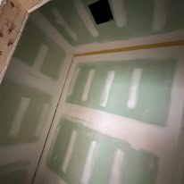 A room with a lot of drywall on the walls and ceiling.