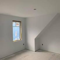 There is a window in the corner of the room.