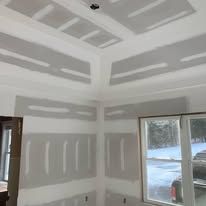 A room with a lot of drywall on the walls and ceiling.