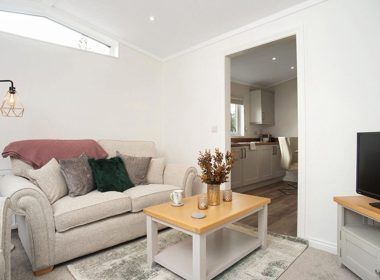 A living room with a couch , coffee table and television.