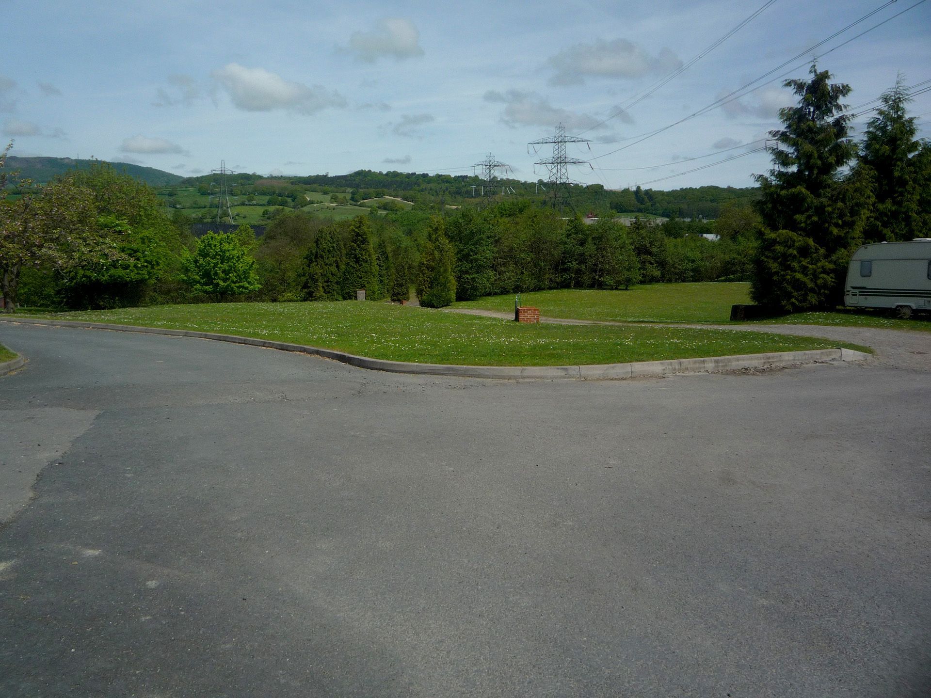 A gray van is parked on the side of the road