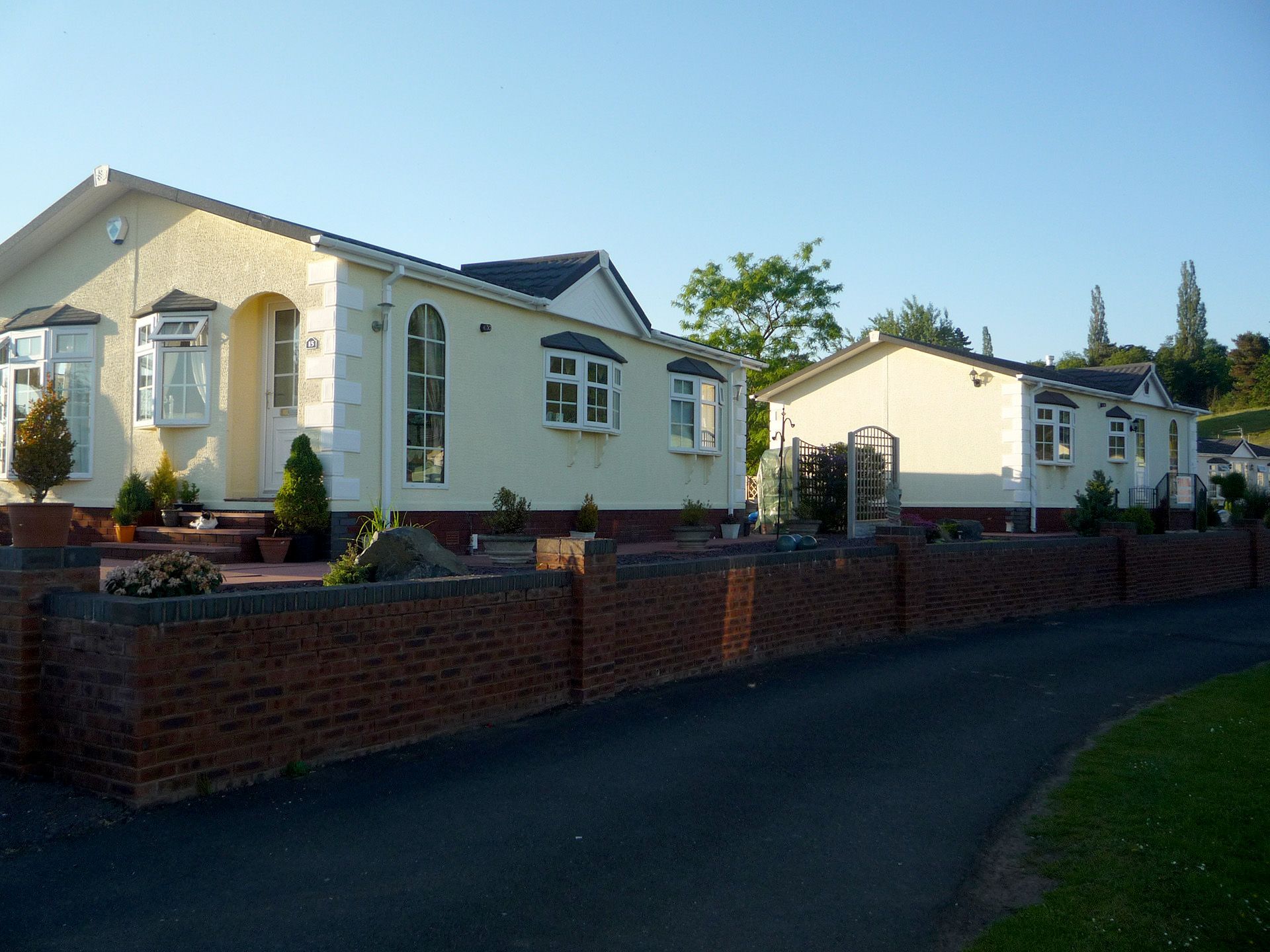 A group of deer statues are standing in a grassy field.