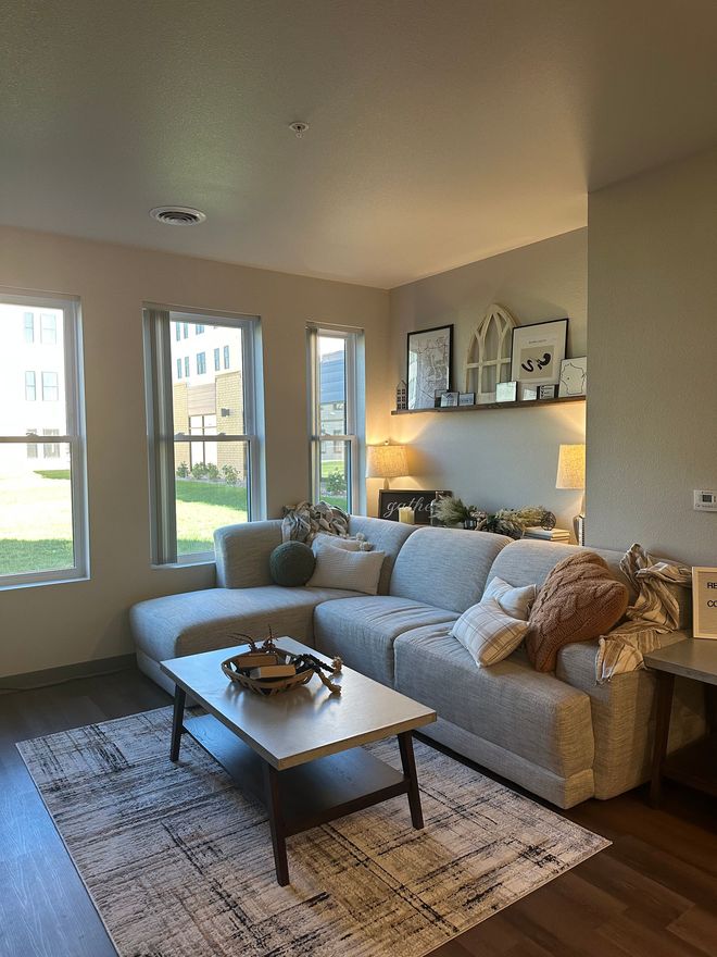 A living room with a sectional couch and a coffee table.