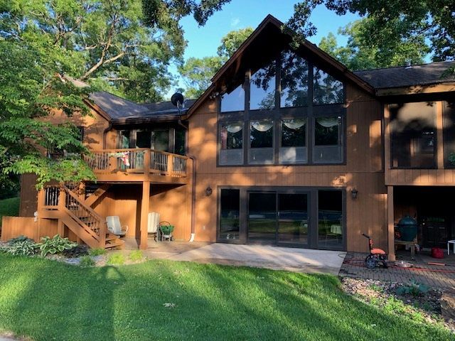 A man is cleaning a patio with a high pressure washer.