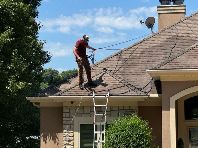 A high pressure washer is sitting on a patio in front of a building.