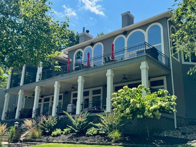 A living room with a table , television , and sliding glass doors.