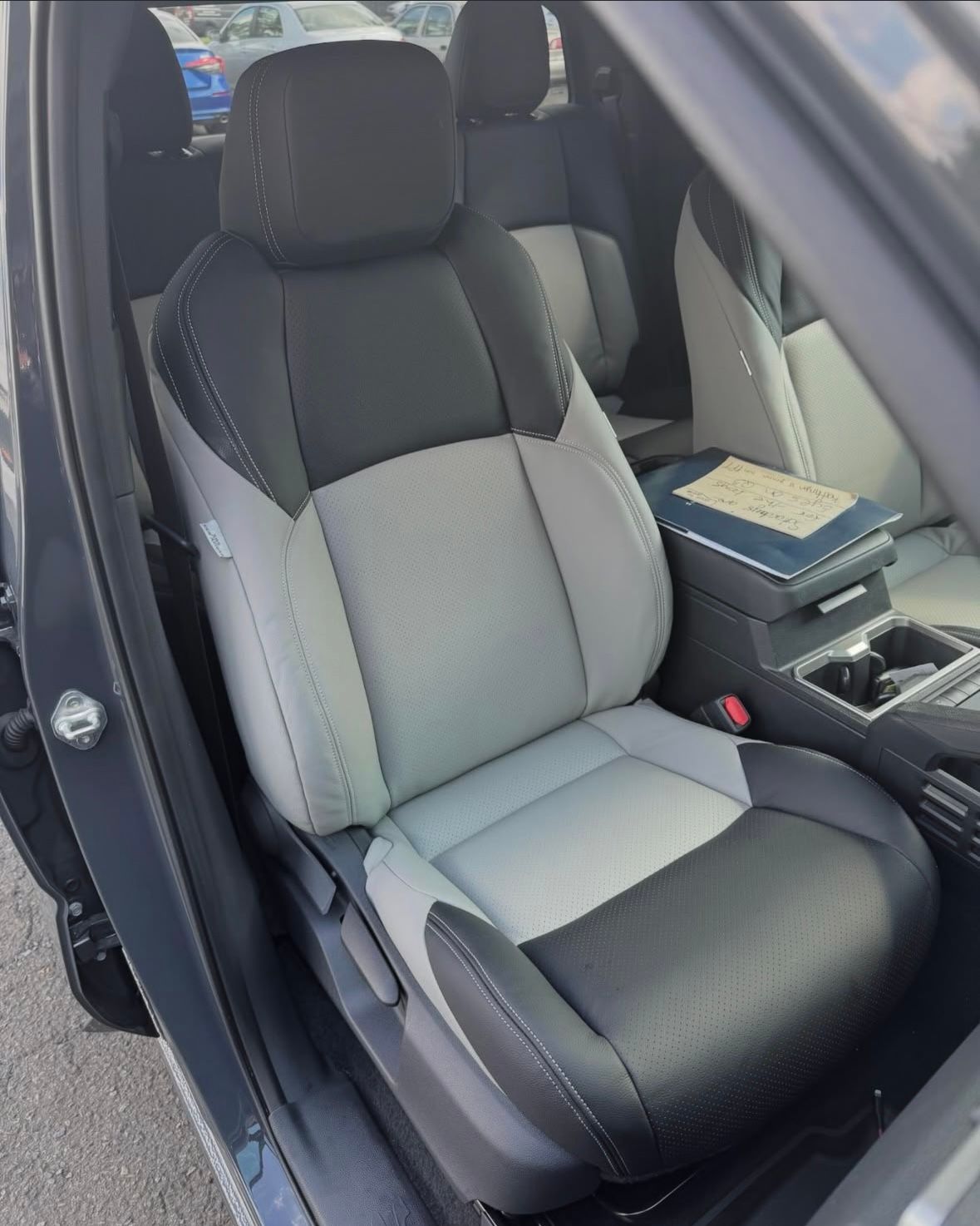 The inside of a car with black and white seats