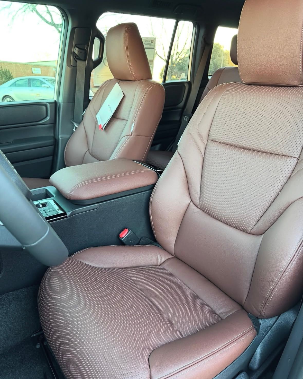 A car with brown leather seats and a steering wheel