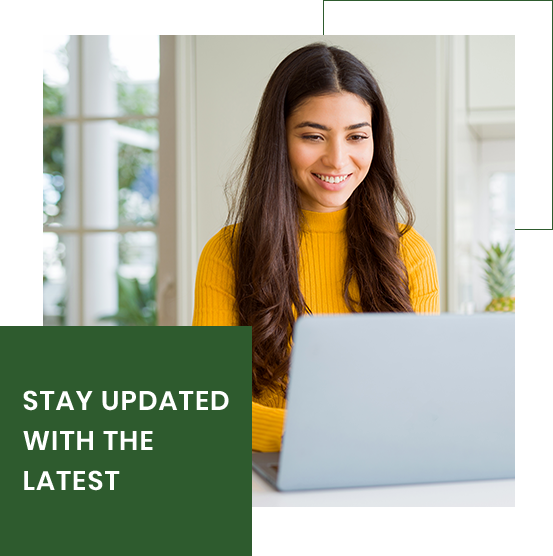 A woman in a yellow sweater is sitting in front of a laptop computer. A woman in a yellow sweater is sitting in front of a laptop computer.