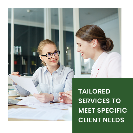 Two women are sitting at a table looking at a piece of paper. Two women are sitting at a table looking at a piece of paper.