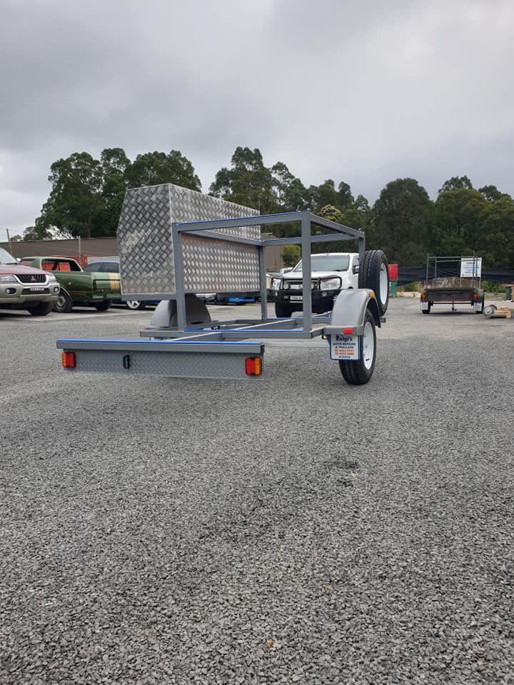 A Small Trailer Is Parked In A Gravel Lot — Fulgi’s South Coast Automotive and Dismantling in Nowra, NSW