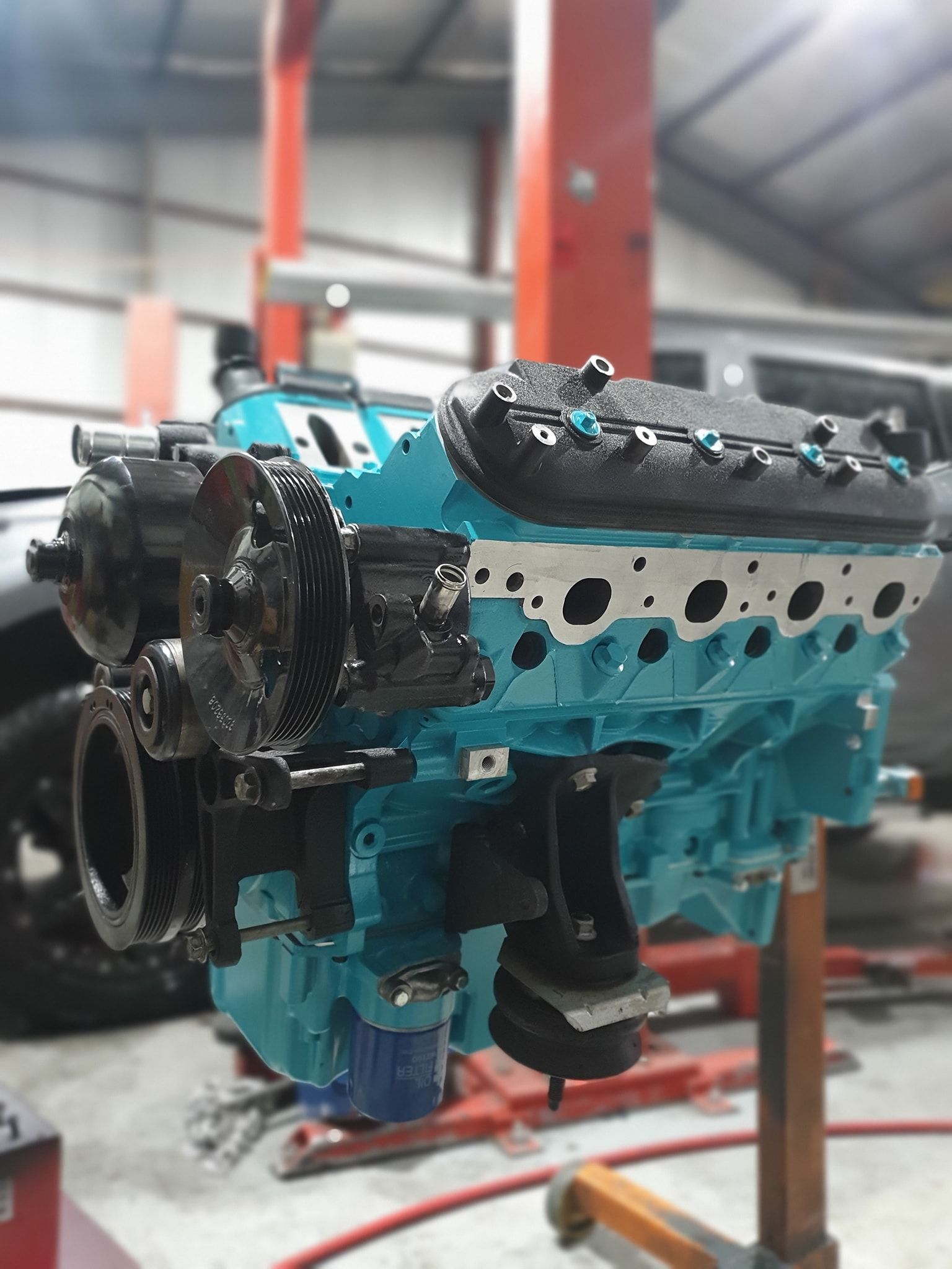 A Blue Engine Is Sitting On A Stand In A Garage — Fulgi’s South Coast Automotive and Dismantling in Nowra, NSW