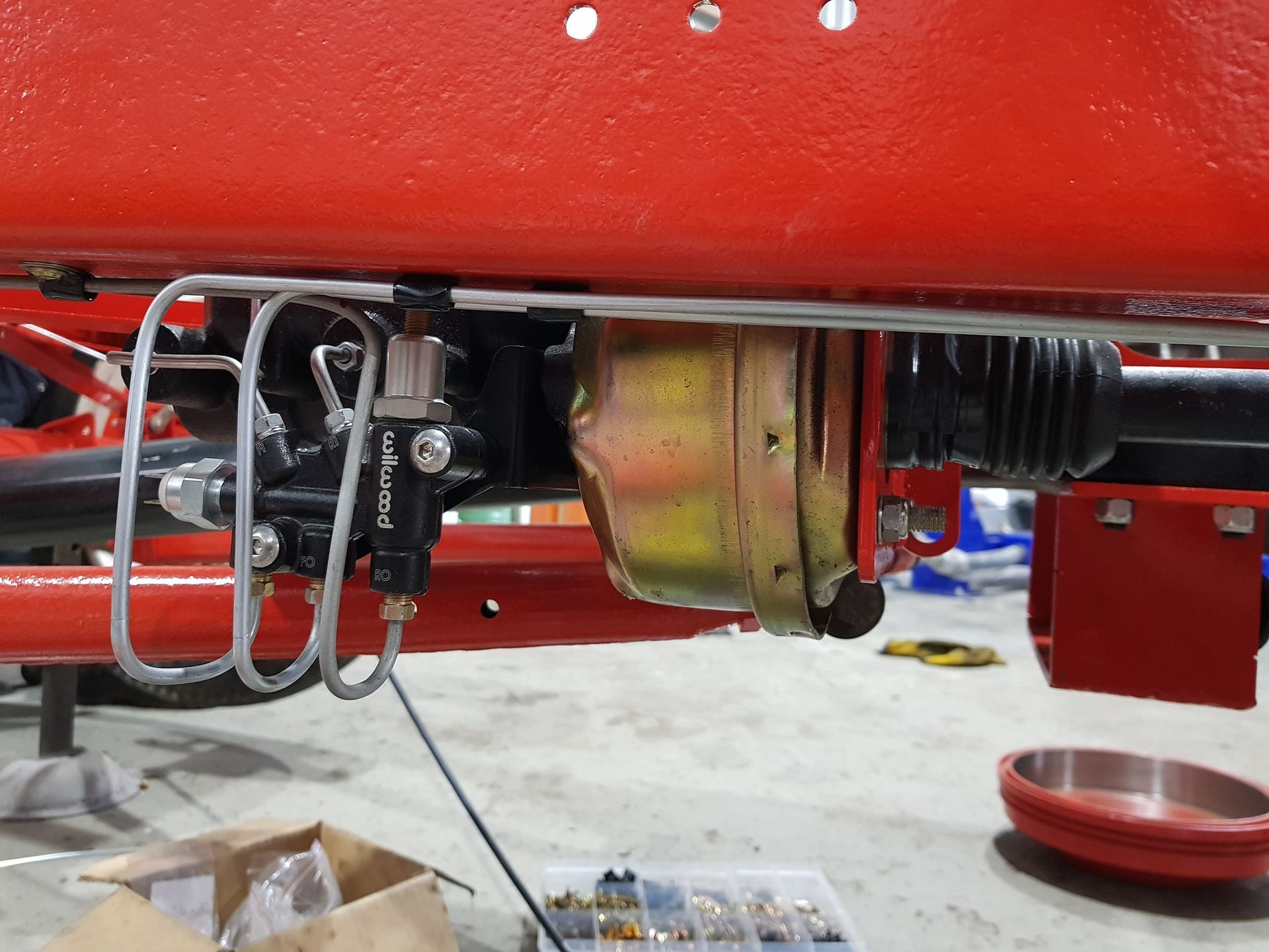 A Red Vehicle Is Being Worked On In A Garage — Fulgi’s South Coast Automotive and Dismantling in Nowra, NSW