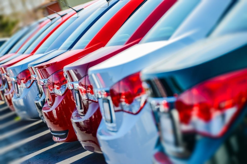 Cars parked in a row. Red, white, and blue cars in the sunlight, at a dealership or lot — Fulgi’s South Coast Automotive and Dismantling in Nowra, NSW