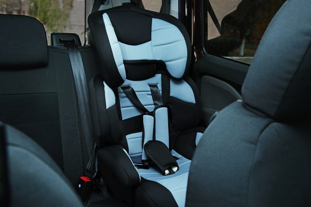 A Child 's Car Seat Is In The Back Seat Of A Car — Fulgi’s South Coast Automotive and Dismantling in Gerringong, NSW