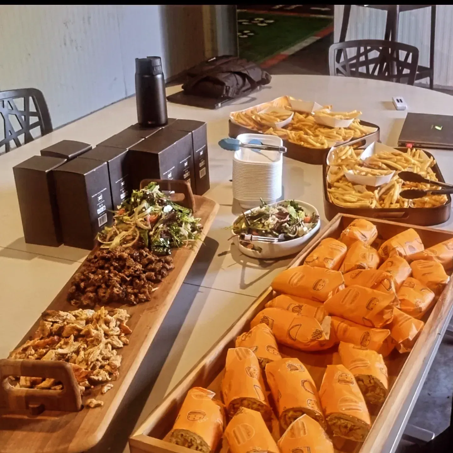 A table topped with a variety of food including sandwiches and french fries