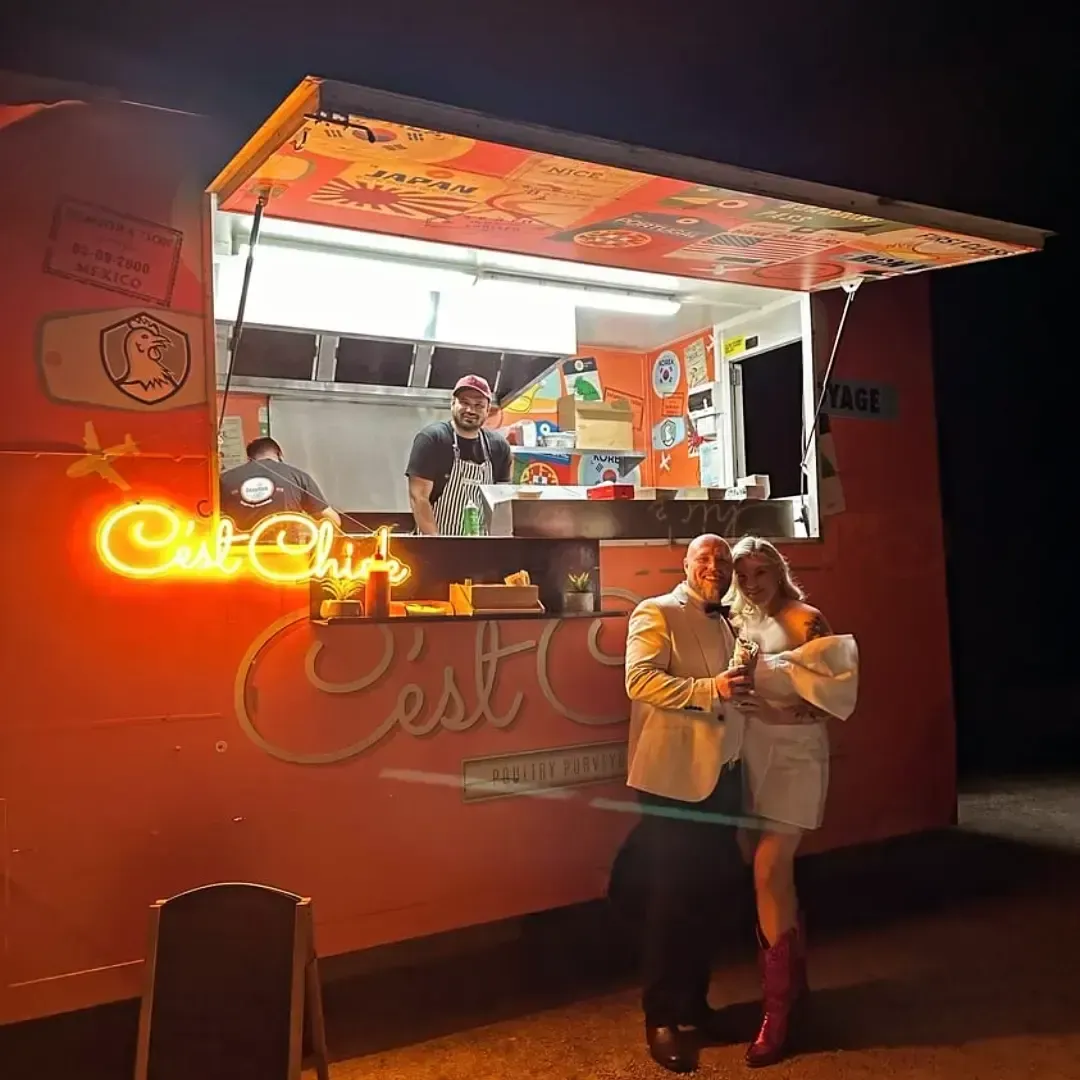 A couple standing in front of a food truck catering in Melbourne.