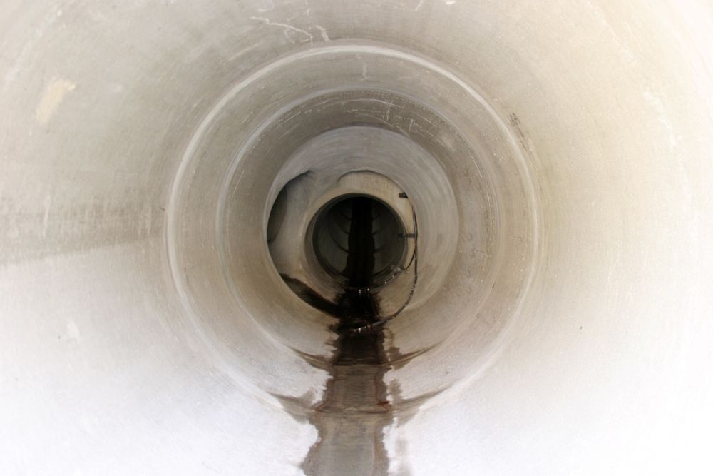 A Close Up Of A Drain Pipe With Water Coming Out Of It— Flash Concreting Pty Ltd In Airlie Beach, QLD
