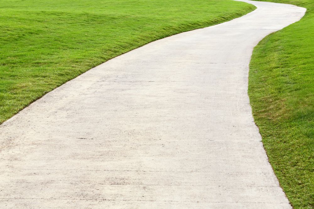 A Concrete Path Going Through A Grassy Field — Flash Concreting Pty Ltd In Proserpine, QLD