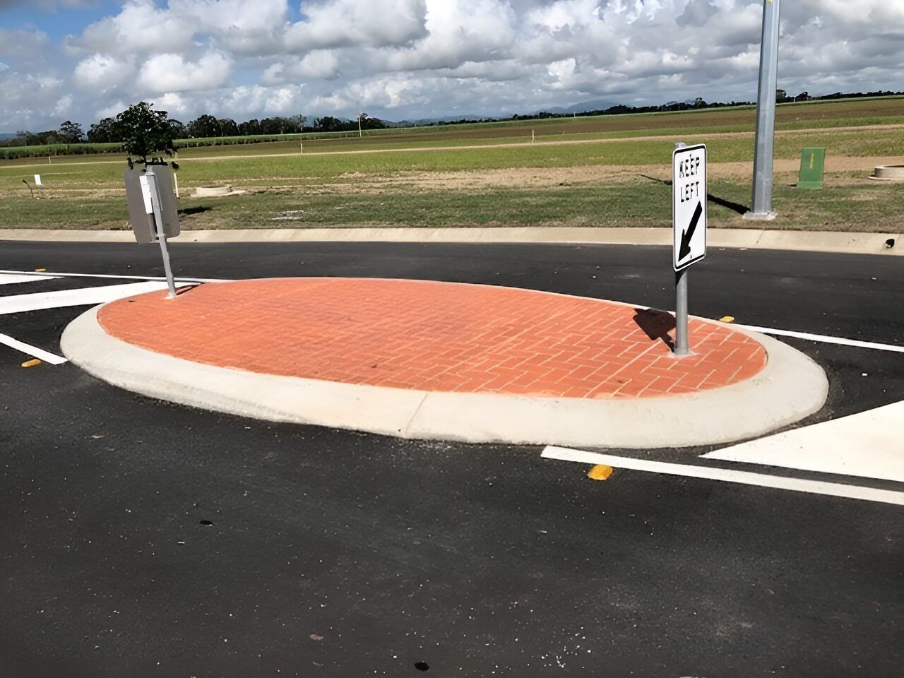 A Roundabout With A Sign On The Side Of It — Flash Concreting Pty Ltd In Proserpine, QLD
