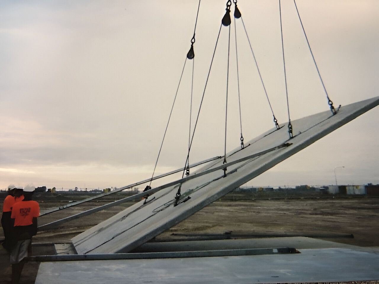 A Large Piece Of Concrete Is Being Lifted By A Crane — Flash Concreting Pty Ltd In Nindaroo, QLD