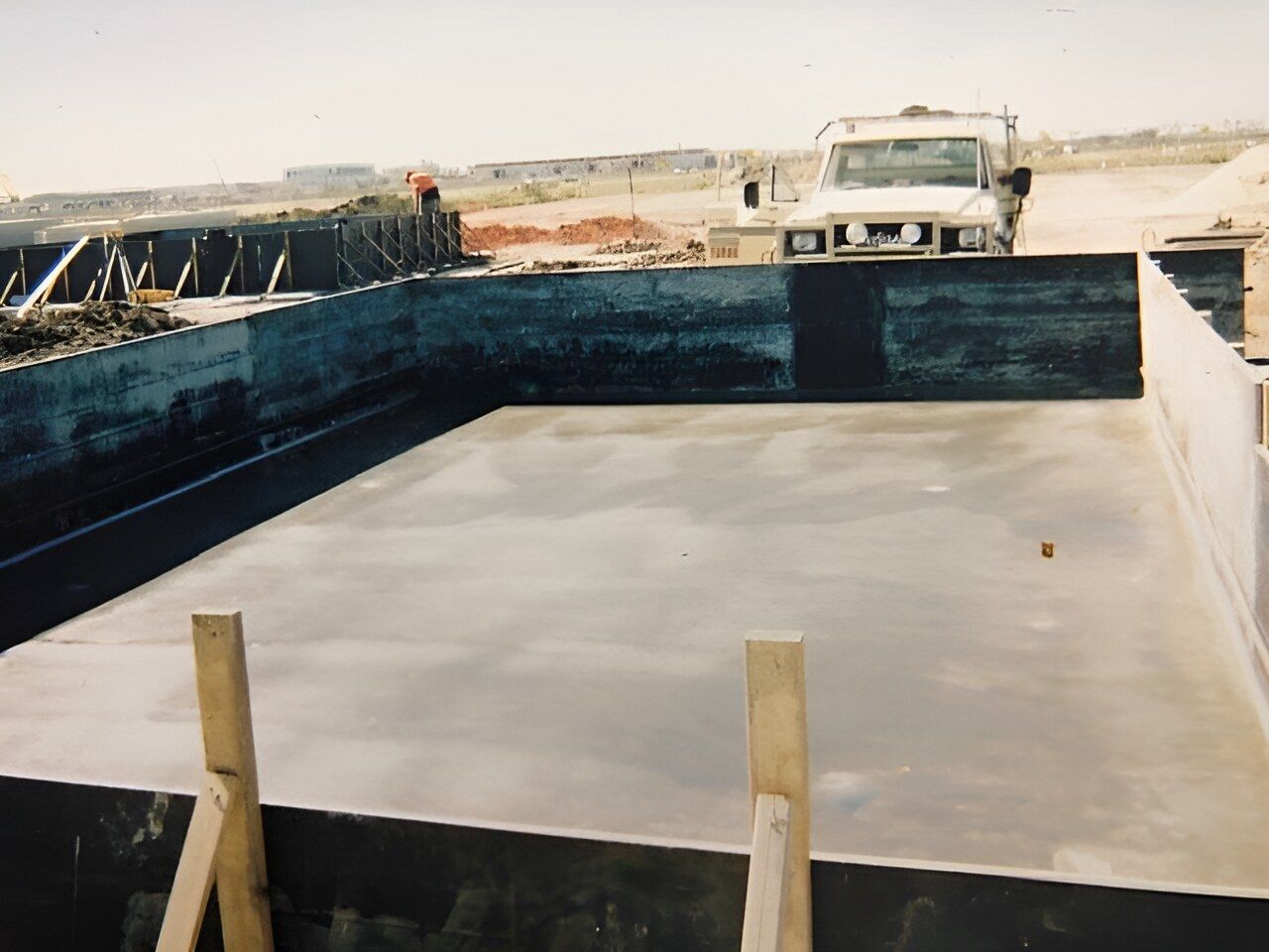 A White Truck Is Parked In Front Of A Large Pool — Flash Concreting Pty Ltd In Airlie Beach, QLD