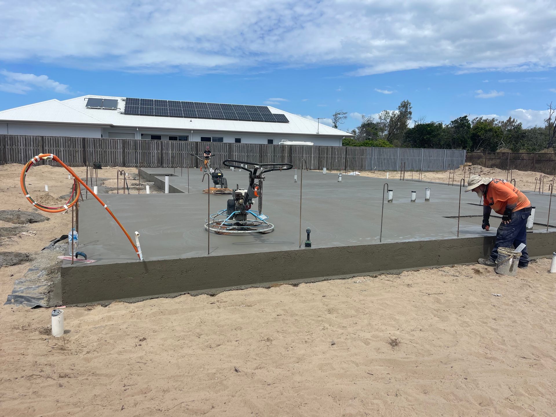 A Brick Fence With Trees In The Background — Flash Concreting Pty Ltd In Nindaroo, QLD