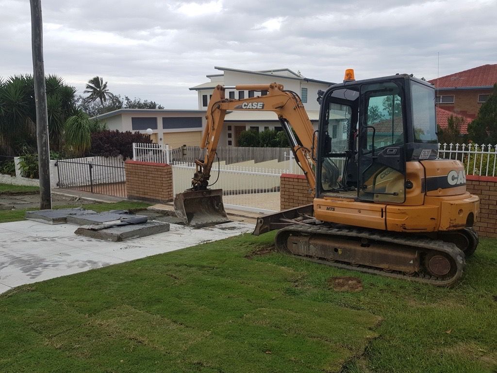 A Small Excavator And A Small Skid Steer Are Parked — Flash Concreting Pty Ltd In Nindaroo, QLD