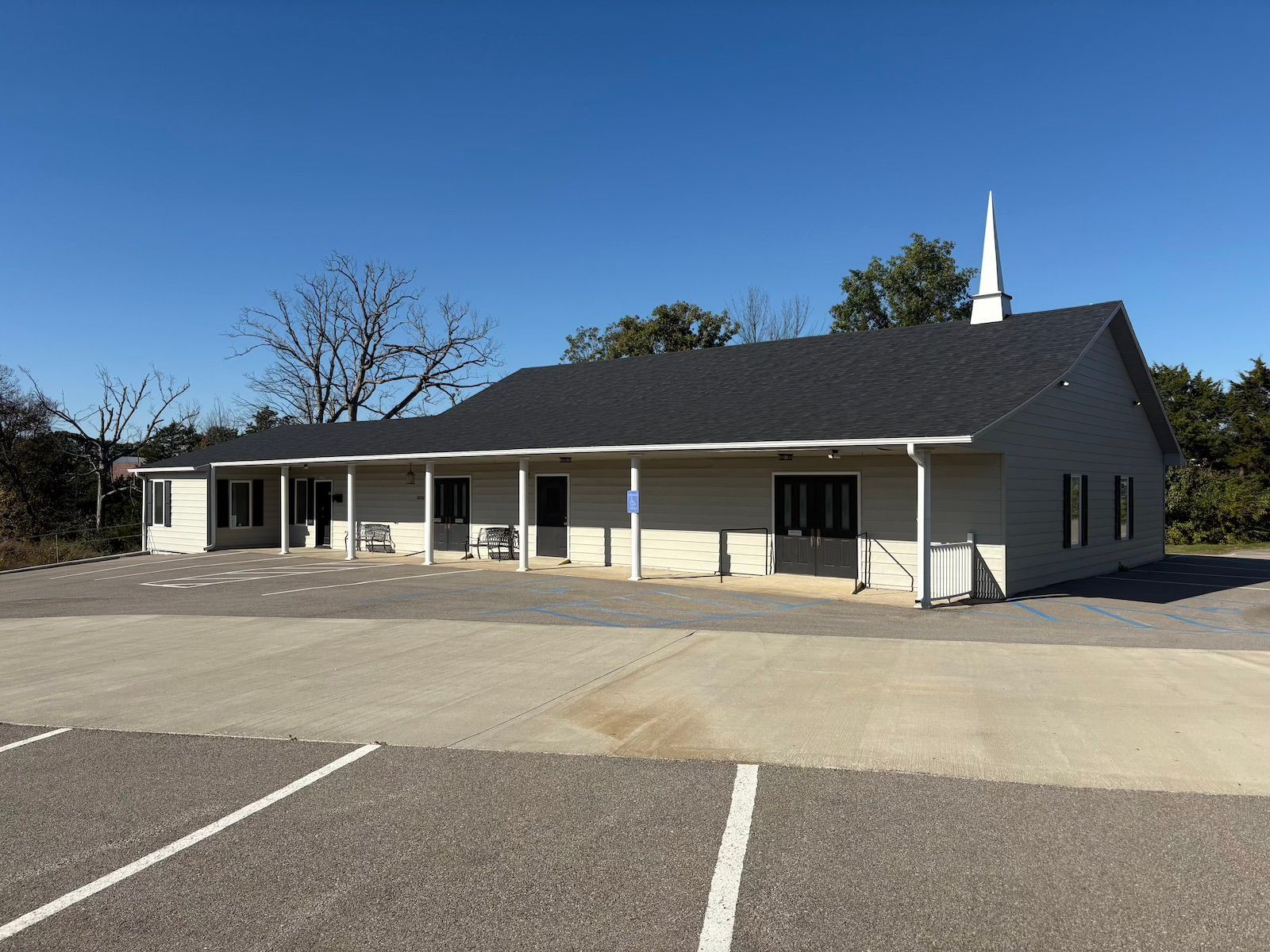 A field surrounded by trees in the fall at sunset