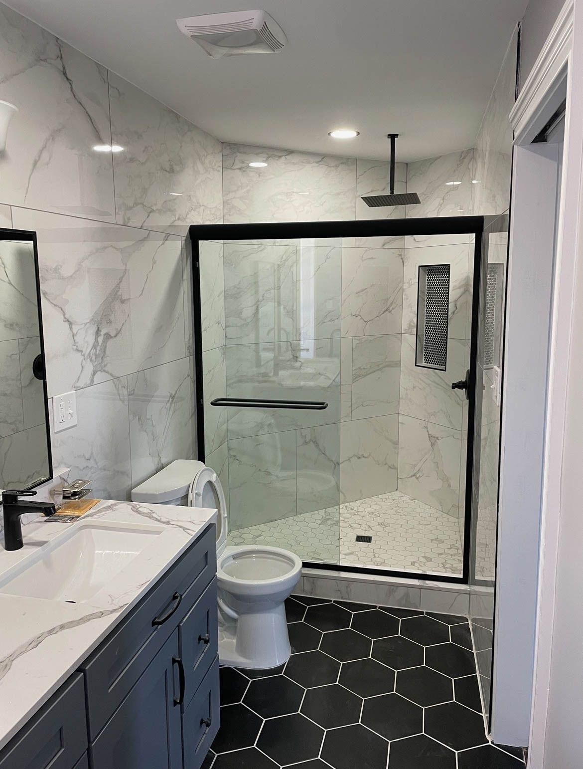 Aqua Plumbing Pros | A bathroom with a toilet , sink , and shower.