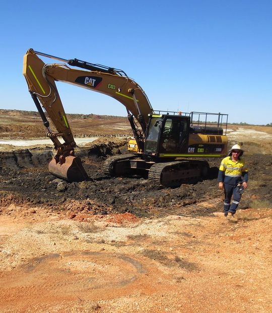 worker behind excavator