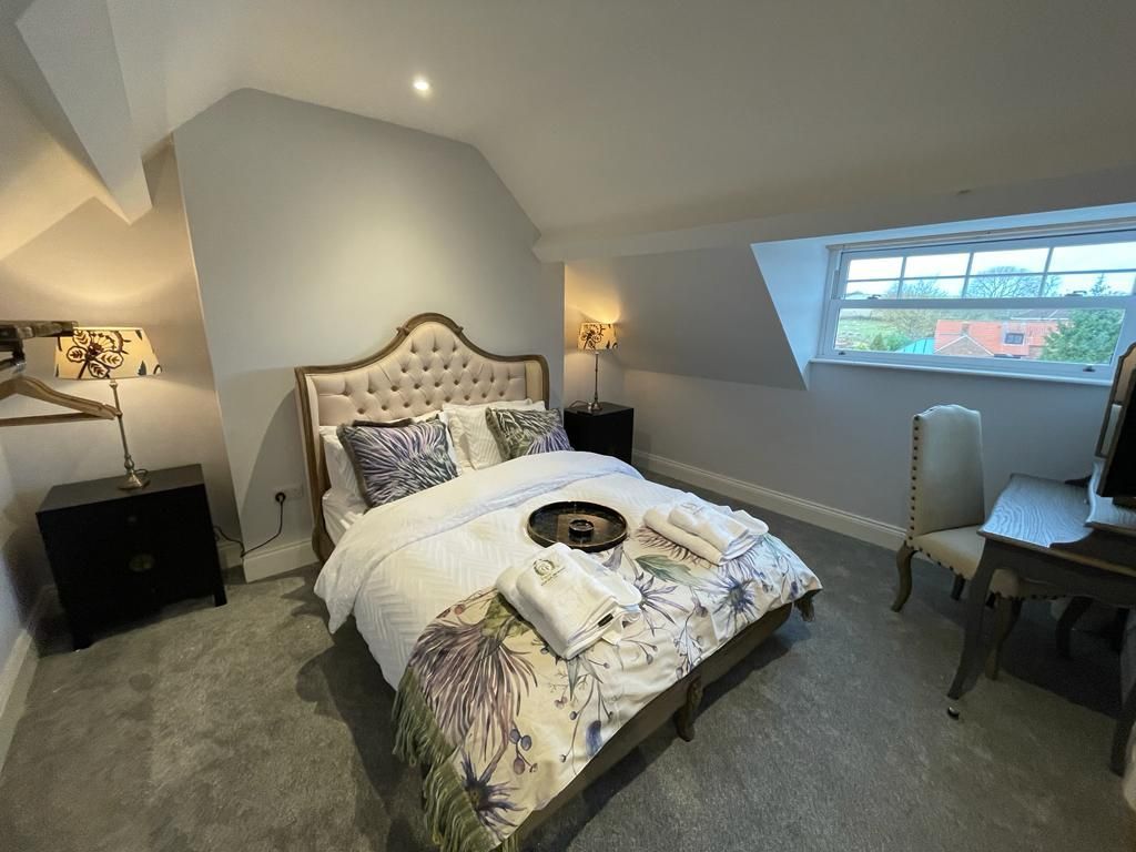 Mulbery House - Master bedroom with stunning frame bed and freee standing furniture