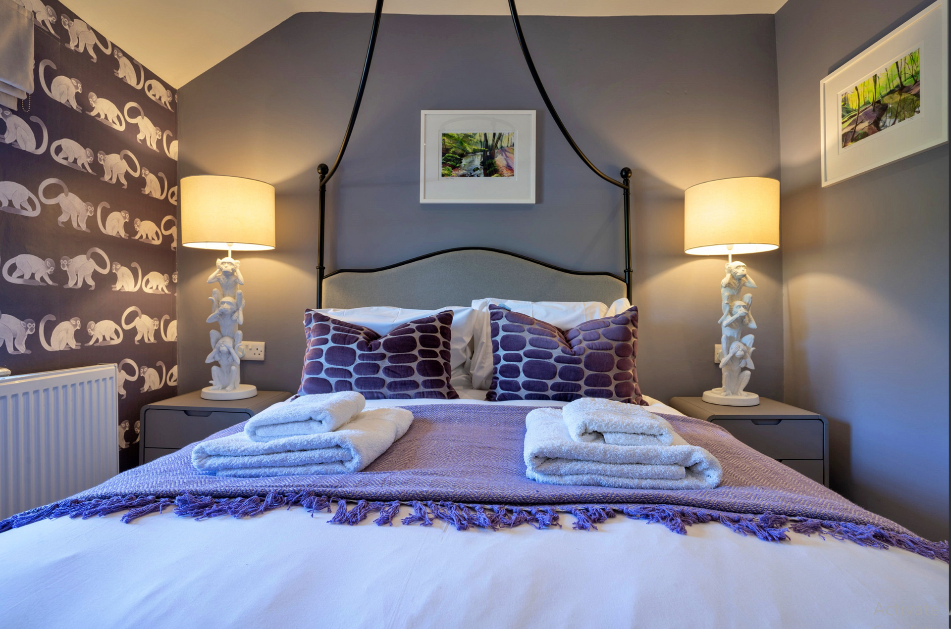 Limestone Cottage - second bedroom with lovely soft purple theme and tall white monkey lamps