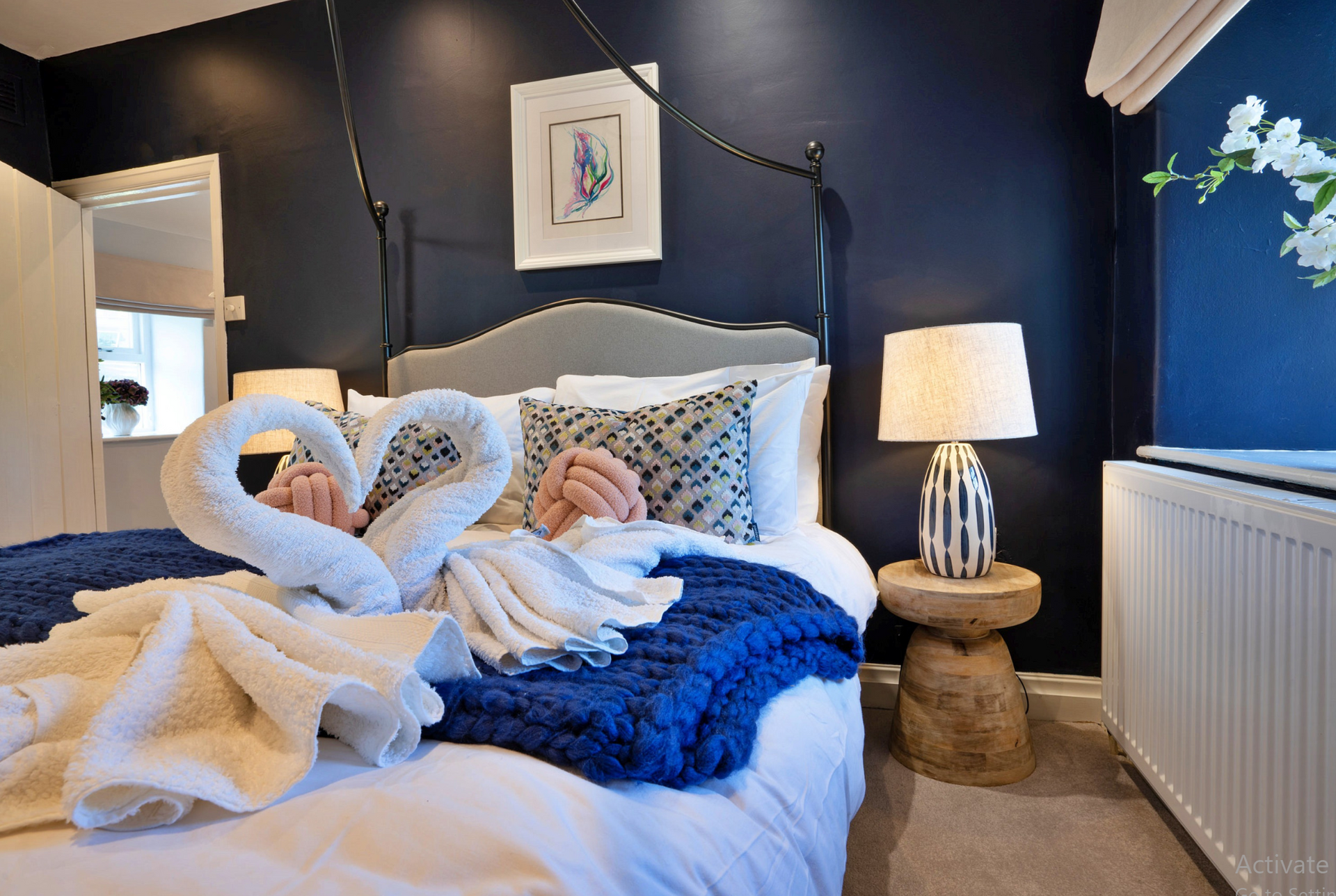 Limestone Cottage - master bedroom with solid side tables and modern lamps
