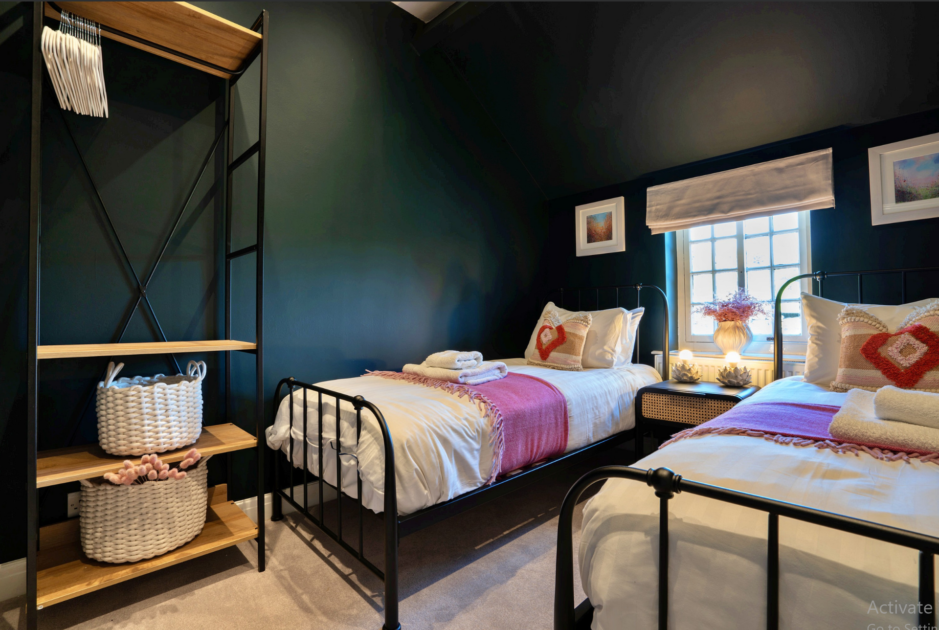 Limestone Cottage - twin bedroom with frame beds and open wardrobe