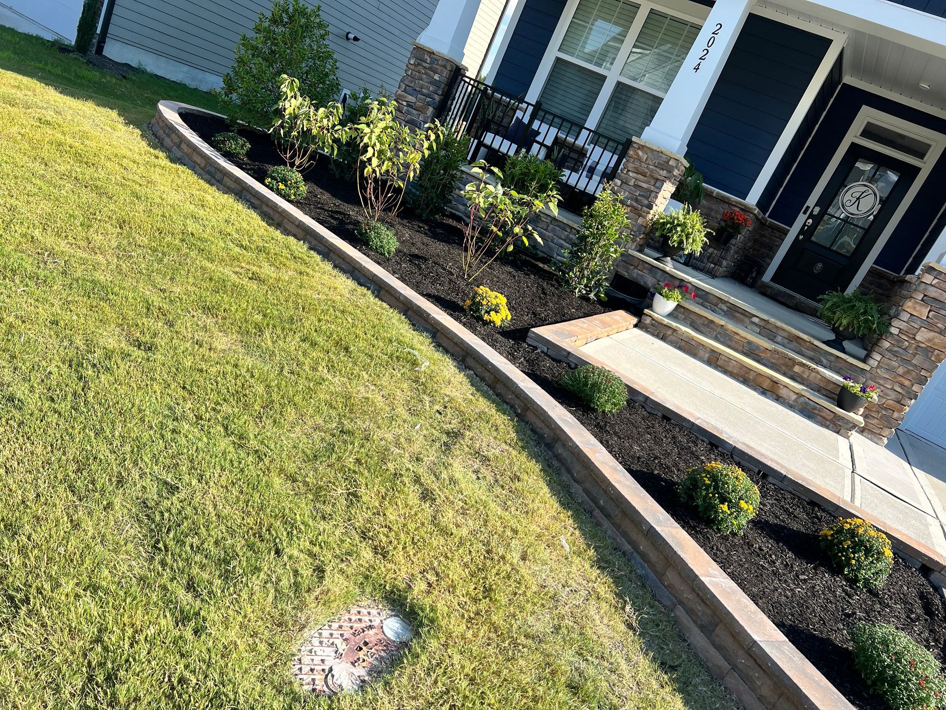 A house with a lush green lawn and a walkway in front of it.