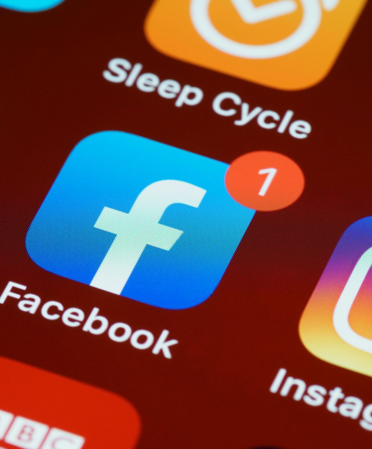 Tandem Growth.  A close up of the facebook app on a phone
