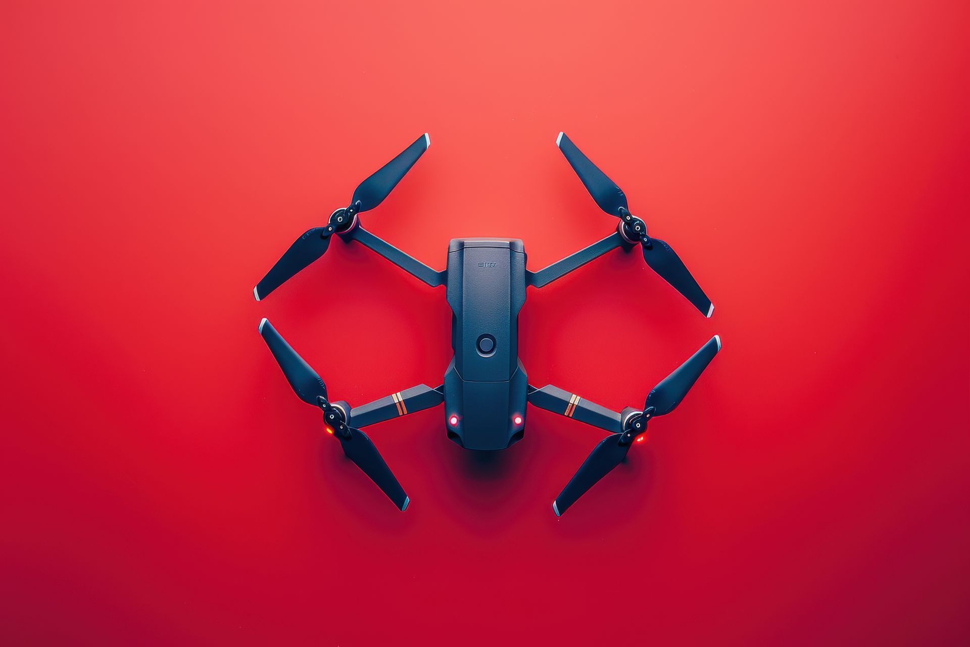 A drone is sitting on top of a red surface.