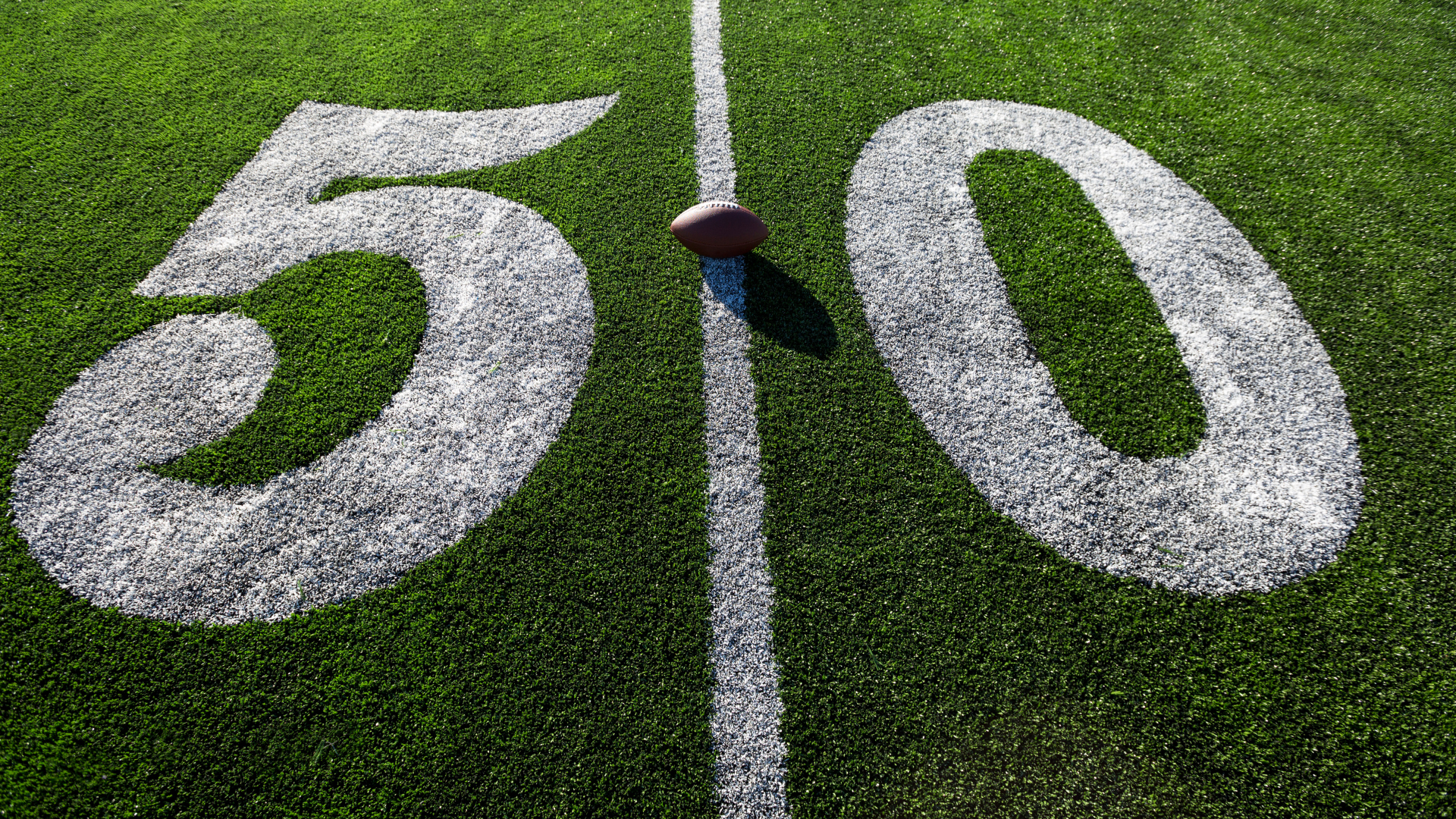 World map with a toy airplane, a black wallet, and passports on top.