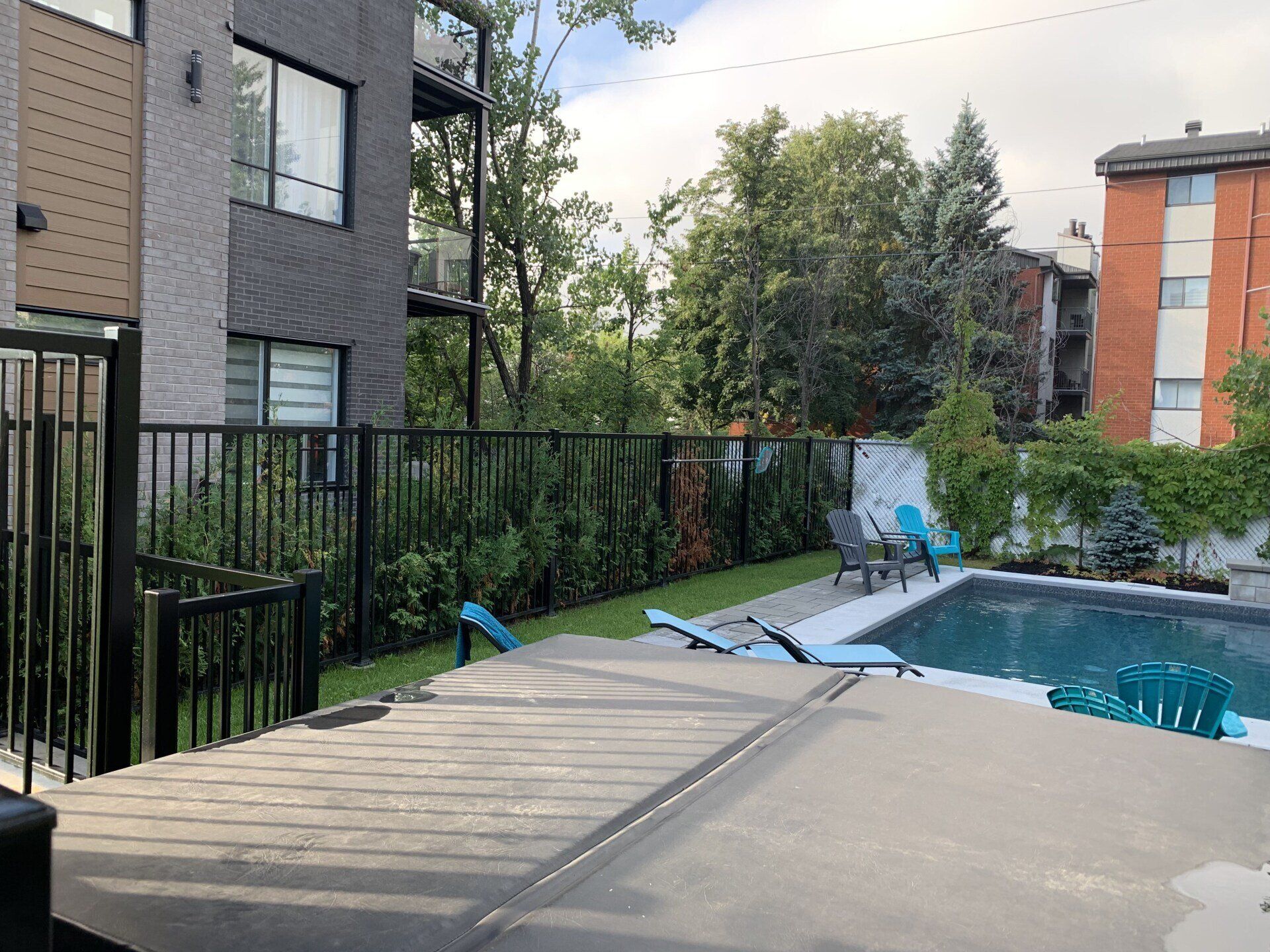 Il y a une grande piscine dans l'arrière-cour d'un immeuble.