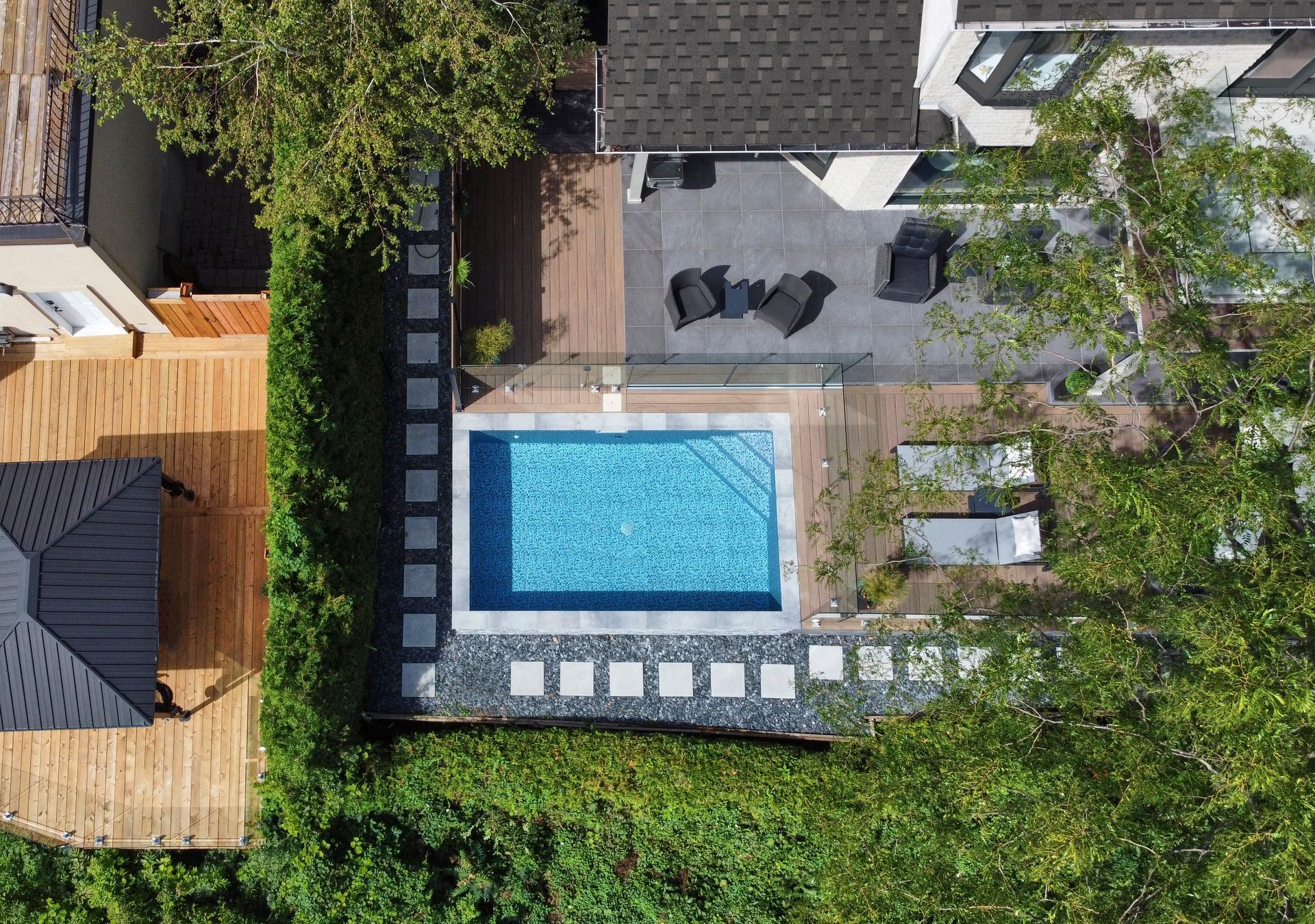 Blue tile pool and hot tub with waterfall and fire features.
