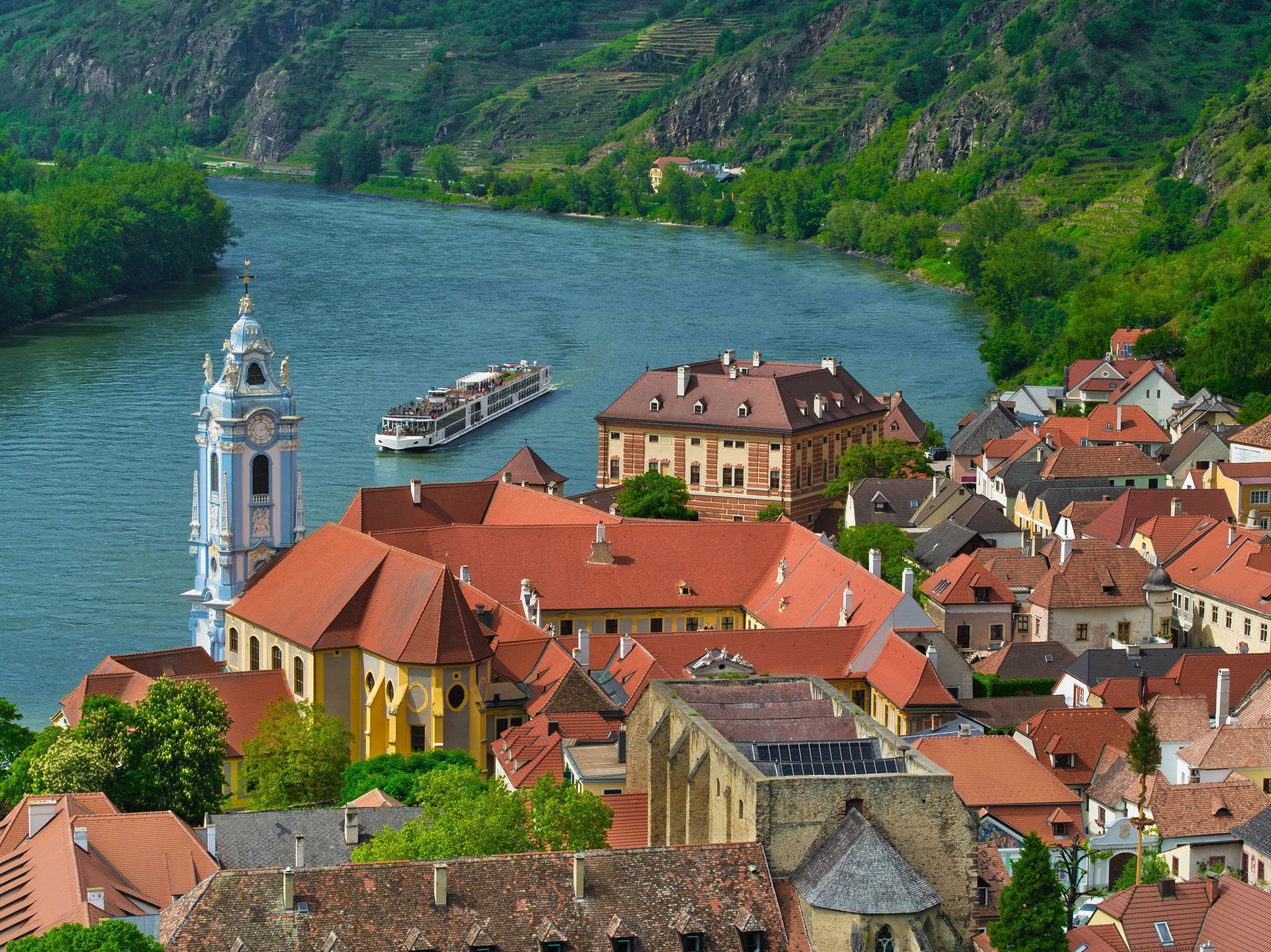 An aerial view of Durnstein, Austria and the Danube river with a river cruise ship