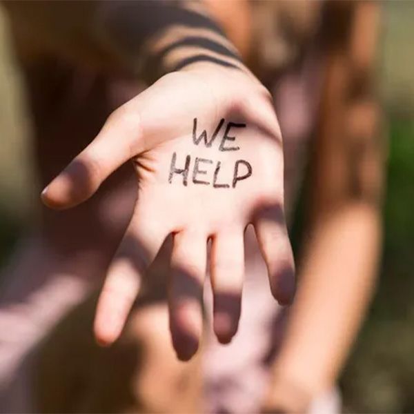 A hand with the words we help written on it