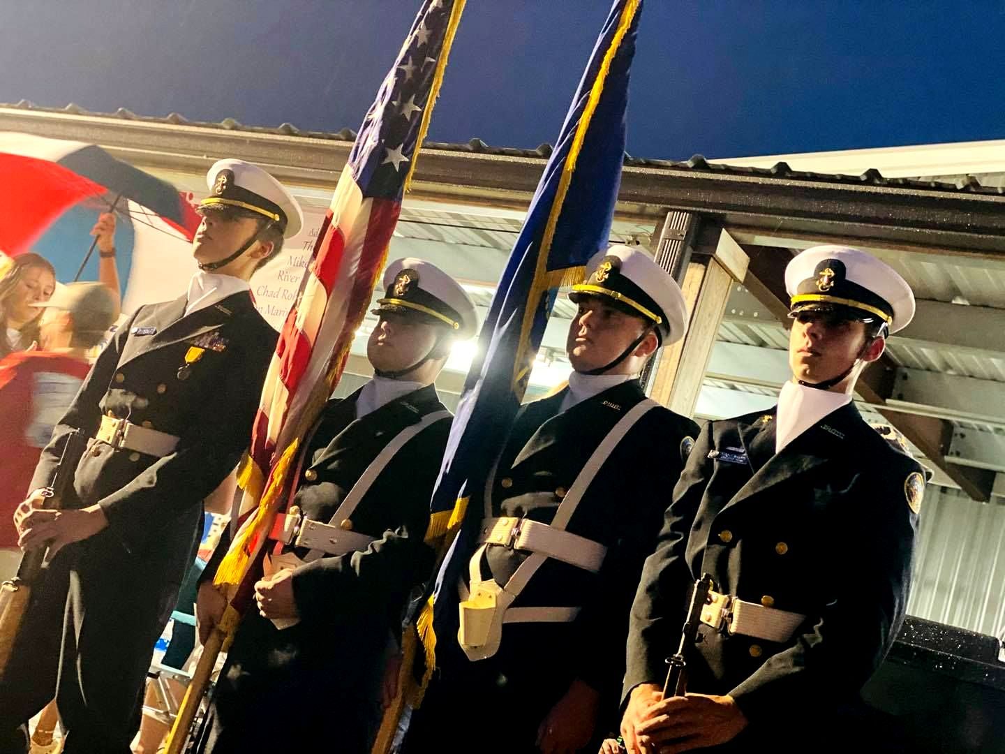 A group of men in military uniforms holding american flags