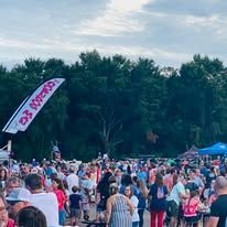 A large group of people are gathered in a park.