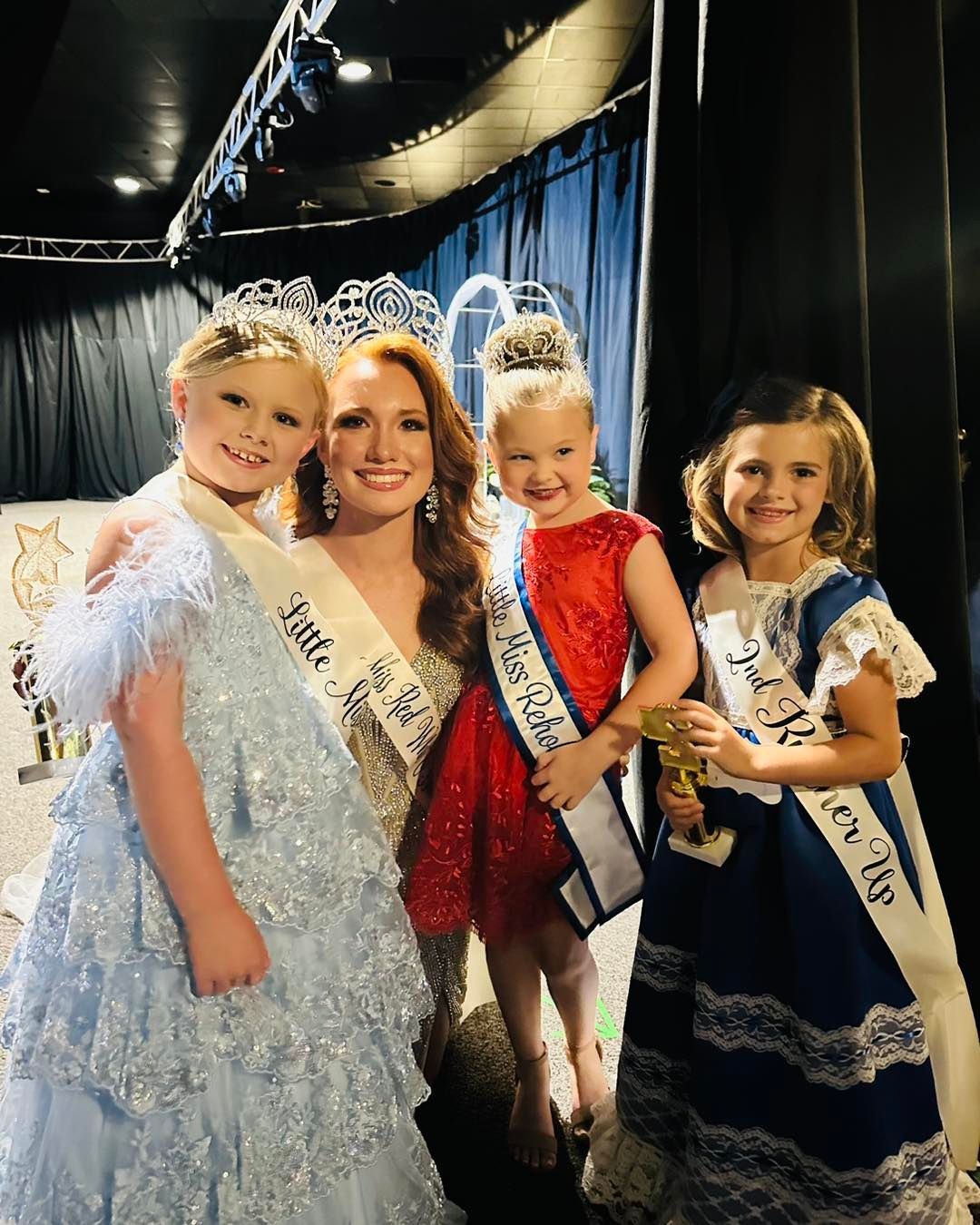 A group of little miss contestants are posing for a picture.
