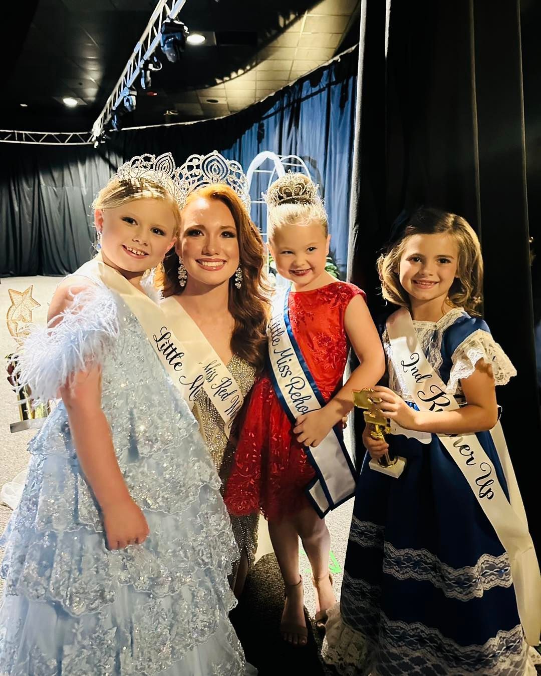 A group of little miss contestants are posing for a picture.