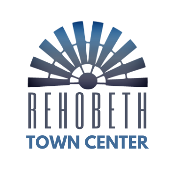 The logo for wiregrass wealth management is a blue circle with a laurel wreath around it.