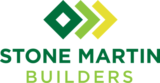 The logo for stone martin builders is green and yellow with arrows pointing in opposite directions.