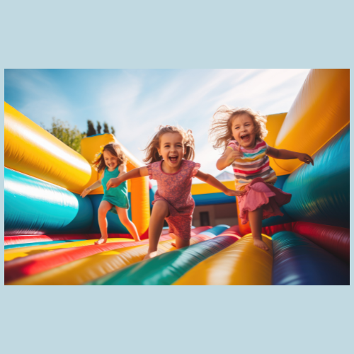 A little girl is riding down an inflatable slide.